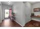 Welcoming entryway with wood flooring, and a coat closet near the red door at 185 Willow Valley Dr, Mooresville, NC 28115