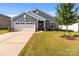Charming single-story home with a well-maintained lawn, attached garage and inviting curb appeal at 185 Willow Valley Dr, Mooresville, NC 28115