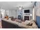 Relax in the inviting living room, complete with a fireplace, ceiling fan, and hardwood floors for cozy comfort at 185 Willow Valley Dr, Mooresville, NC 28115