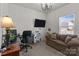 Comfortable living room features a chandelier, a sofa, a desk, and a large window at 185 Willow Valley Dr, Mooresville, NC 28115