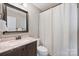 Cozy bathroom with updated vanity, framed mirror, and a shower with white curtain at 1925 Sandal Brook Rd, Indian Land, SC 29707