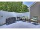 Cozy patio space includes seating, a barbecue, and tasteful landscaping for relaxing outdoor enjoyment at 1925 Sandal Brook Rd, Indian Land, SC 29707