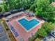 Aerial view showcases a heart-shaped community pool with lounge chairs and shaded areas for residents' enjoyment at 1925 Sandal Brook Rd, Indian Land, SC 29707