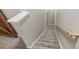 Carpeted stairway with a wooden handrail, leading to upper or lower levels of the home at 1925 Sandal Brook Rd, Indian Land, SC 29707