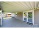 Spacious, covered back porch with a gray wood deck and double glass doors leading into the house at 2031 36Th Ne St, Hickory, NC 28601