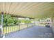 Long, covered back porch offering an excellent outdoor space with a view of the backyard and neighborhood at 2031 36Th Ne St, Hickory, NC 28601