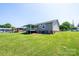 Back exterior featuring a covered deck and an expansive grassy backyard at 2031 36Th Ne St, Hickory, NC 28601