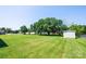 Spacious backyard featuring a well-maintained lawn, mature trees, and a storage shed for outdoor equipment at 2031 36Th Ne St, Hickory, NC 28601