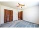 This bedroom features a ceiling fan and a closet with wood doors at 2031 36Th Ne St, Hickory, NC 28601