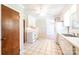 Well-lit kitchen with white cabinets, appliances, a tile floor, and an adjacent living space creating an inviting atmosphere at 2031 36Th Ne St, Hickory, NC 28601
