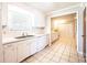 Bright kitchen with white cabinetry, tile floors, and a window over the sink at 2031 36Th Ne St, Hickory, NC 28601