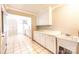Open concept kitchen featuring white cabinets, a sink, and a tile floor, seamlessly connecting to other living spaces at 2031 36Th Ne St, Hickory, NC 28601