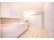 Functional laundry room featuring a sink, lots of cabinet space, and a large closet for storage at 2031 36Th Ne St, Hickory, NC 28601