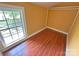 Bedroom featuring hardwood floors, yellow walls, and natural light from a window at 2131 E Nc 10 Hwy, Conover, NC 28613
