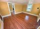 Bedroom with wood floors, yellow walls and white trim at 2131 E Nc 10 Hwy, Conover, NC 28613