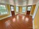 Bedroom with yellow walls, wood floors, and two windows at 2131 E Nc 10 Hwy, Conover, NC 28613