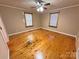 Sunlit bedroom featuring hardwood floors, neutral walls, and a ceiling fan at 2131 E Nc 10 Hwy, Conover, NC 28613