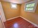 Cozy bedroom featuring hardwood floors and natural light from white-trimmed windows at 2131 E Nc 10 Hwy, Conover, NC 28613