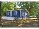 Charming blue home with white trim, porch, and mature trees surrounding the property at 2131 E Nc 10 Hwy, Conover, NC 28613