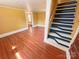 Hallway featuring wood floors, yellow walls and a stairwell at 2131 E Nc 10 Hwy, Conover, NC 28613