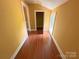 Hallway features wood floors and yellow walls, offering a view into the next room at 2131 E Nc 10 Hwy, Conover, NC 28613