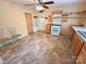 Traditional kitchen design with white appliances, light cabinetry and a ceiling fan at 2131 E Nc 10 Hwy, Conover, NC 28613