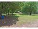 Expansive yard with mature trees and a glimpse of the charming home in the distance at 2131 E Nc 10 Hwy, Conover, NC 28613