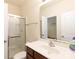 Bathroom featuring a shower with glass door, updated fixtures, and a large single sink vanity at 2180 Shady Pond Dr, Clover, SC 29710