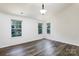 Spacious bedroom with three windows allowing for great natural light and wood-look flooring at 2180 Shady Pond Dr, Clover, SC 29710