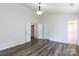 Open bedroom featuring wood-look flooring, multiple windows, and interior doors at 2180 Shady Pond Dr, Clover, SC 29710