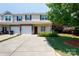 Inviting townhome showcasing a one-car garage, stone details, and a neatly landscaped yard at 2180 Shady Pond Dr, Clover, SC 29710