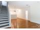 Open-concept living room featuring hardwood floors, great natural light, and an inviting staircase at 2180 Shady Pond Dr, Clover, SC 29710