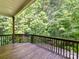 View of the back deck overlooking a lush green forest at 2215 Henery Tuckers Ct, Charlotte, NC 28270