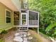 Exterior view of a screened-in porch with steps leading to the backyard at 2215 Henery Tuckers Ct, Charlotte, NC 28270