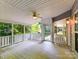 Covered back porch with a ceiling fan and view of lush greenery at 2215 Henery Tuckers Ct, Charlotte, NC 28270