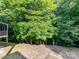 Spacious backyard with mature trees providing shade and privacy at 2215 Henery Tuckers Ct, Charlotte, NC 28270