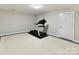 Finished basement area with a treadmill and neutral walls at 2215 Henery Tuckers Ct, Charlotte, NC 28270