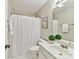 Cozy bathroom with toilet, white sink, vanity, and shower with white curtain at 2215 Henery Tuckers Ct, Charlotte, NC 28270