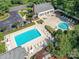 Aerial view of a neighborhood pool featuring lounge chairs, umbrellas, and a clubhouse at 2215 Henery Tuckers Ct, Charlotte, NC 28270