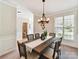 Dining room featuring a wooden table, decorative chandelier and neutral paint at 2215 Henery Tuckers Ct, Charlotte, NC 28270