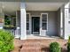 Close up of front porch with brick steps, white columns and black front door with sidelights at 2215 Henery Tuckers Ct, Charlotte, NC 28270