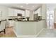 Bright kitchen featuring white cabinets, granite countertops, and stainless steel appliances at 2215 Henery Tuckers Ct, Charlotte, NC 28270