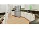 Modern kitchen with stainless steel refrigerator, white cabinets, and dark countertops at 2215 Henery Tuckers Ct, Charlotte, NC 28270