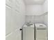 Neat laundry area with washer, dryer, wire shelving, and white painted walls at 2215 Henery Tuckers Ct, Charlotte, NC 28270
