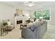 Comfortable living room featuring a fireplace, neutral paint, and a large window at 2215 Henery Tuckers Ct, Charlotte, NC 28270