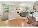 Open-concept living room featuring hardwood floors, fireplace, neutral paint and abundant natural light at 2215 Henery Tuckers Ct, Charlotte, NC 28270