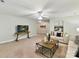 Spacious living room featuring plush sofas, ceiling fan, and large windows at 2215 Henery Tuckers Ct, Charlotte, NC 28270