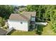 Aerial view showcasing the home's backyard with covered patio, and white picket fence at 229 Cramerton Mills Pkwy, Cramerton, NC 28032