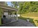 Inviting covered patio featuring a ceiling fan overlooking the manicured lawn and white picket fence at 229 Cramerton Mills Pkwy, Cramerton, NC 28032