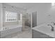 Elegant bathroom with double vanity, glass shower, and soaking tub, featuring a modern design at 229 Cramerton Mills Pkwy, Cramerton, NC 28032
